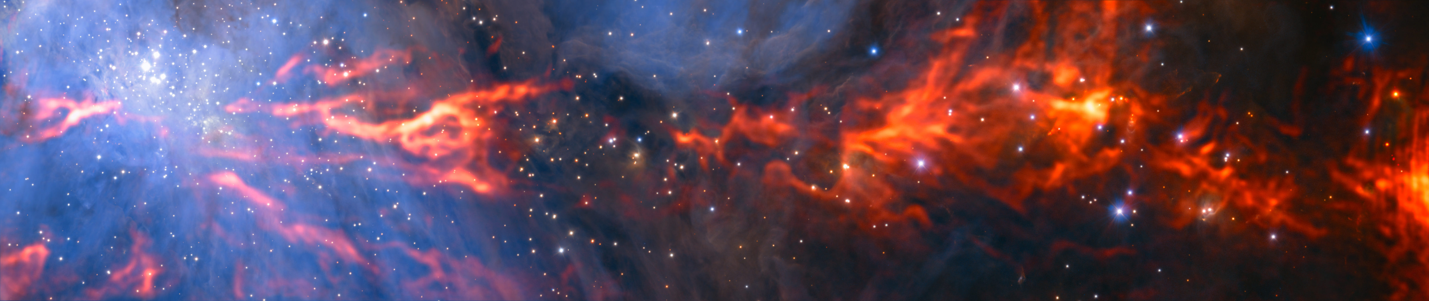 Esta espectacular e inusual imagen muestra parte de la famosa nebulosa de Orión, una región de formación estelar que se encuentra a unos 1350 años luz de la Tierra. Combina un mosaico de imágenes en longitud de onda milimétrica obtenidas por el radiotelescopio ALMA (Atacama Large Millimeter/submillimeter Array) y el telescopio IRAM de 30 metros, que se ven en rojo, con una vista infrarroja más conocida, obtenida por el instrumento HAWK-I, instalado en el Very Large Telescope de ESO, y que se muestra en azul. El grupo de estrellas brillantes de color blanco-azulado de la parte superior izquierda es el Cúmulo del Trapecio, formado por estrellas jóvenes calientes de tan solo unos pocos millones de años. Crédito: ESO/H. Drass/ALMA (ESO/NAOJ/NRAO)/A. Hacar