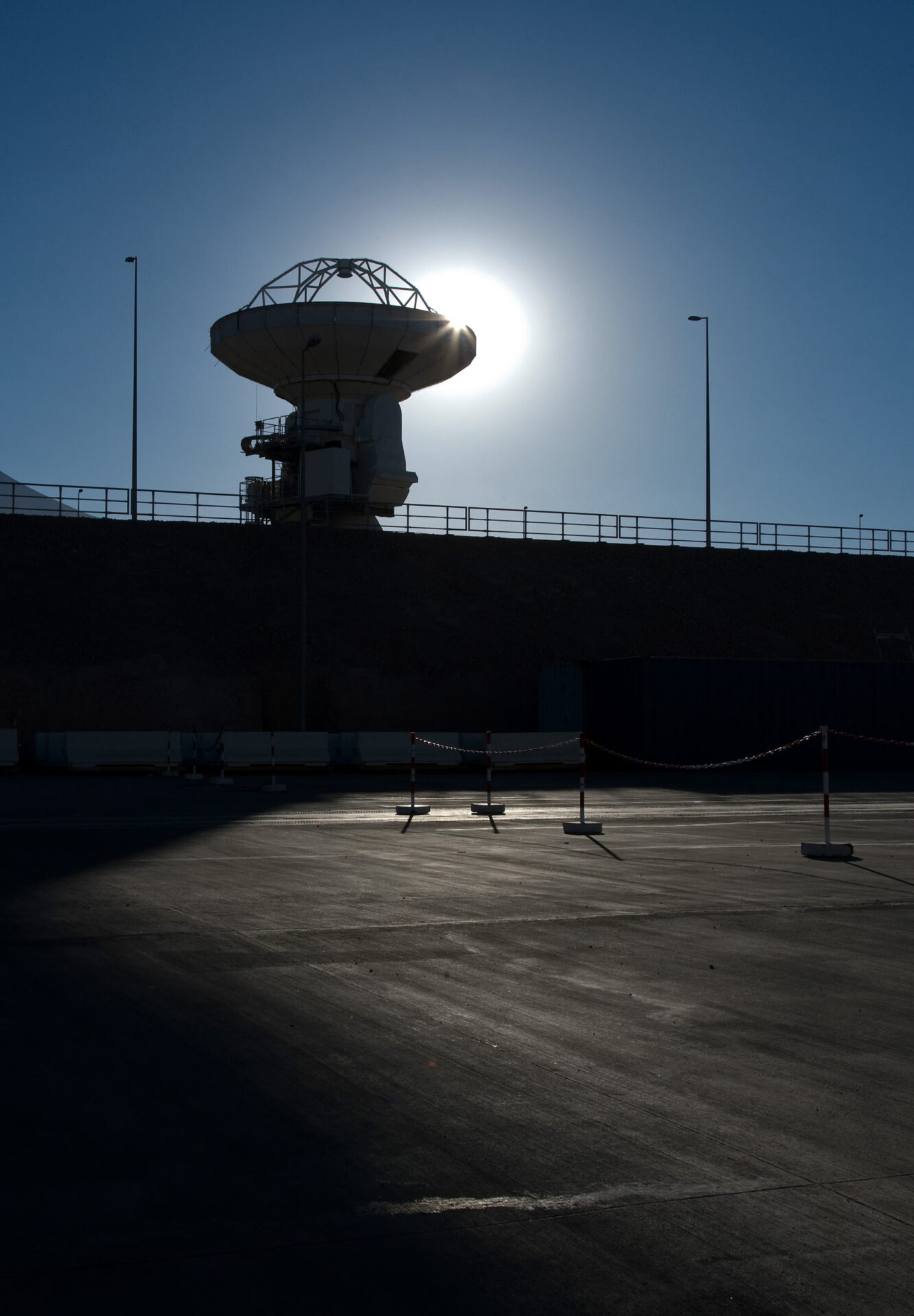 ALMA antenna at OSF backlit by the Sun